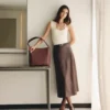 woman carrying brown tote handbag stylish shoulder bag lifestyle image