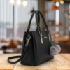 black handbag side angle view with shoulder strap stylish tote bag for women