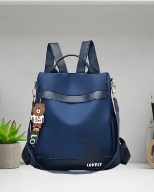 Stylish navy blue women’s backpack purse displayed on modern table setup indoors