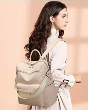 Woman carrying an elegant beige backpack purse with adjustable straps and modern minimalist designStylish women’s backpack purse designed with spacious compartments, premium leather-texture finish, and versatile carry options for travel, shopping, office, and everyday fashion use.Stylish women’s backpack purse designed with spacious compartments, premium leather-texture finish, and versatile carry options for travel, shopping, office, and everyday fashion use.