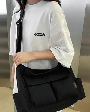 Large black canvas messenger shoulder bag with multiple pockets and adjustable strap