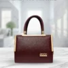 Luxury maroon leather handbag for women with gold detailing and elegant top handle design